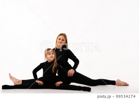 Sporty mom and her little daughter in thermal clothes. Sporty mom and her little daughter in thermal clothes. 99534274