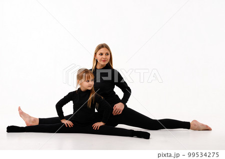 Sporty mom and her little daughter in thermal clothes. Sporty mom and her little daughter in thermal clothes. 99534275