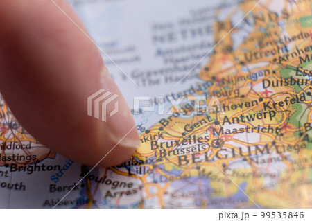 Finger pointing to Brussels, Belgium on colorful map with selective focus, shallow depth of field, background blur. High quality photo Finger pointing to Brussels, Belgium on colorful map with selective focus, shallow depth of field, background blur. High quality photo 99535846