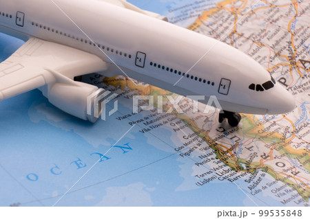 Close up of map with miniature passenger plane highlighting Lisbon, Portugal through selective focus, shallow depth of field, background blur. High quality photo 99535848