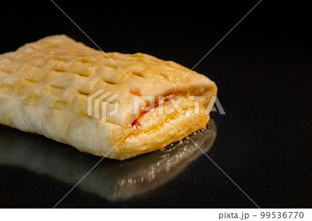 Bun with red strawberry jam baking in electric oven: close up Bun with red strawberry jam baking in electric oven: close up 99536770