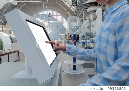 Woman hand touching interactive white touchscreen display kiosk: close up Woman hand touching interactive white touchscreen display kiosk: close up 99536808