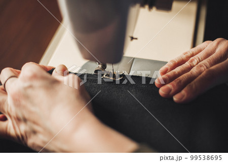 Woman working with sewing machine 99538695