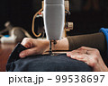 Woman working with sewing machine 99538697