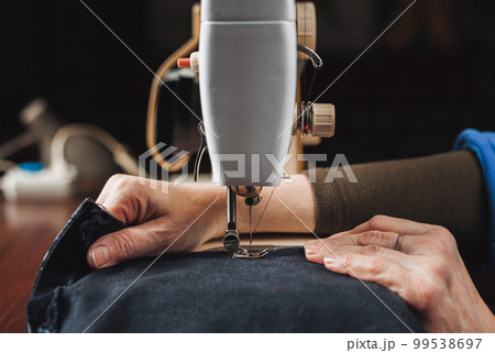 Woman working with sewing machine 99538697