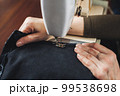Woman working with sewing machine 99538698