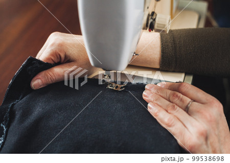 Woman working with sewing machine 99538698