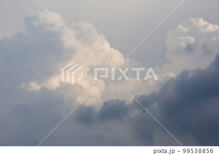 Private Jet Plane Passing Vast Rain Clouds Private Jet Plane Passing Vast Rain Clouds 99538856