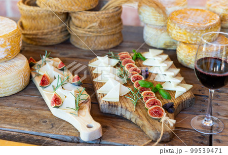 Cheese plate - cheeses and figs on wooden background 99539471