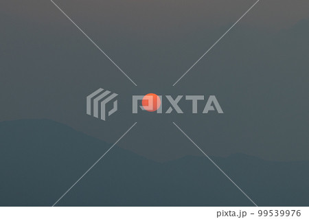 日本　山口県柳井市と愛媛県松山市を結ぶフェリーの船上から見える島々と霞んだ空に沈みゆく夕日 99539976