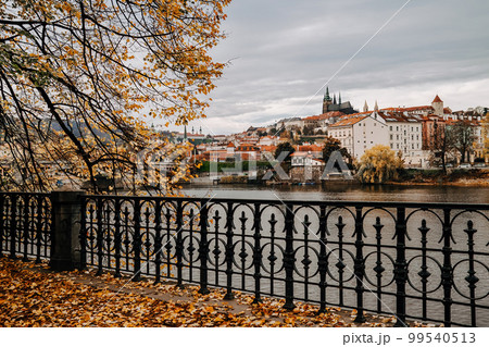 Beautiful autumn cityscape of Prague with Vltava river. St Vita Cathedral Beautiful autumn cityscape of Prague with Vltava river. St Vita Cathedral 99540513