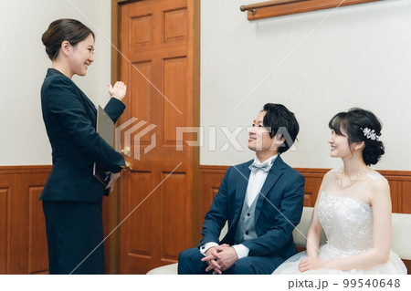 結婚式場・ホテルで働くスーツ姿のコンシェルジュ・ホテルマン・ホテリエ・ウェディングプランナーの男女 99540648