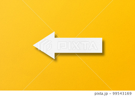 white paper arrow isolated on yellow paper background white paper arrow isolated on yellow paper background 99543169