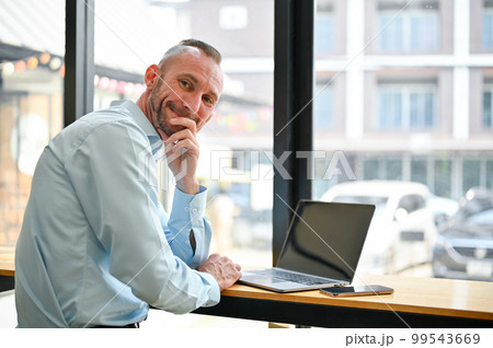 Happy Caucasian businessman or male office worker remote working at the coffee shop 99543669