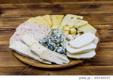 Cheese platter with different kinds of cheese on wooden table 99546055
