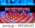 Vodka or tequila shots on bar counter in night club 99546103
