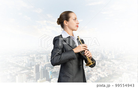 Business woman playing the trumpet Business woman playing the trumpet 99554943