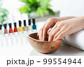 Woman hands in wooden bowl with water 99554944