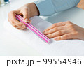 Woman using nail file and create nails shape 99554946