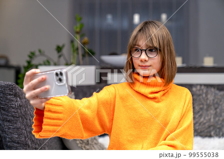 a child communicates online on a smartphone a child communicates online on a smartphone 99555038