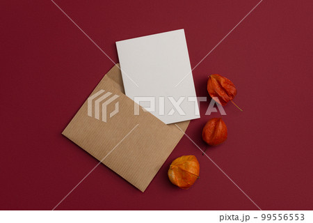 A ?raft postal letter adorned with a composition of dried flowers on a red background 99556553
