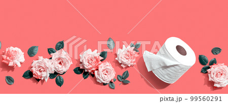 Toilet paper with pink roses overhead view 99560291