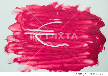 Euro sign painted on the textures of the sample smear lipstick 99560776