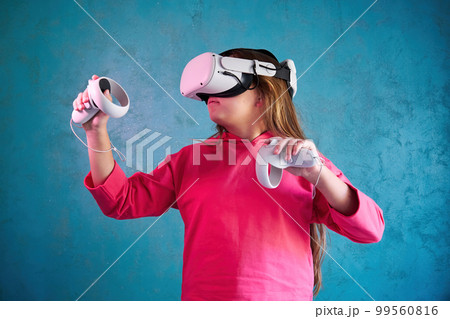 little girl playing with VR glasses 99560816