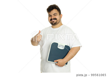 Concept of weight loss, man with scales, isolated on white background 99561065