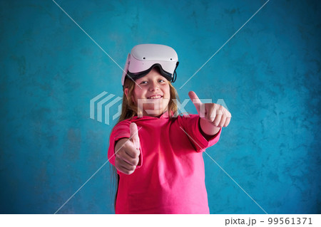 little girl playing with VR glasses 99561371