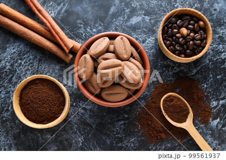 Concept of tasty snack for hot drink - cookies in the shape of coffee seeds 99561937