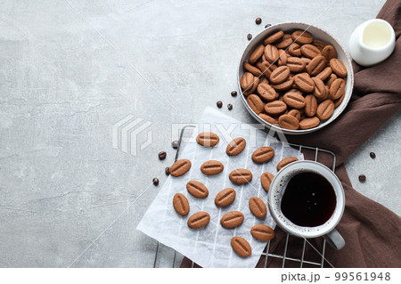 Concept of tasty snack for hot drink - cookies in the shape of coffee seeds 99561948