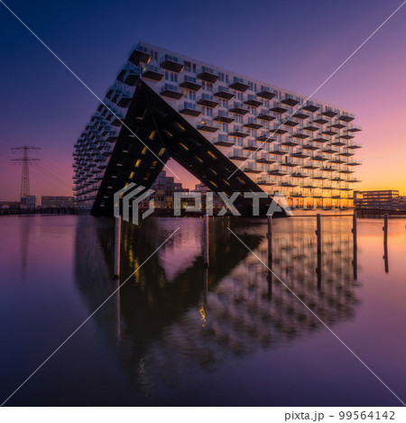 Amsterdam, Netherlands. A cityscape during sunset. Architecture of the Netherlands. Amsterdam, Netherlands. A cityscape during sunset. Architecture of the Netherlands. 99564142