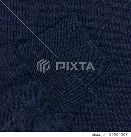 Blue wool sweater sleeve close up Blue wool sweater sleeve close up 99564503