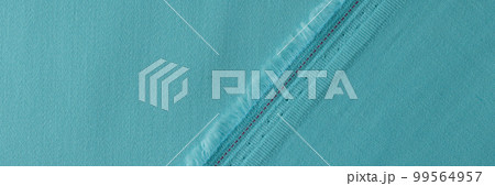 Light blue fabric with fringe and seam closeup Light blue fabric with fringe and seam closeup 99564957