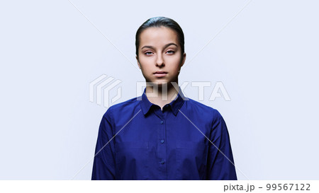 Portrait of sad teenager girl looking at camera on white background 99567122