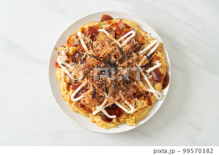 Japanese Traditional Pizza that called Okonomiyaki Japanese Traditional Pizza that called Okonomiyaki 99570382