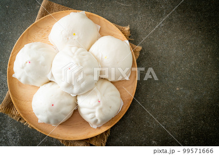 stuffed steamed bun on wood plate stuffed steamed bun on wood plate 99571666