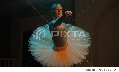 Ballet dancer preparing and stretching before performance Ballet dancer preparing and stretching before performance 99571712