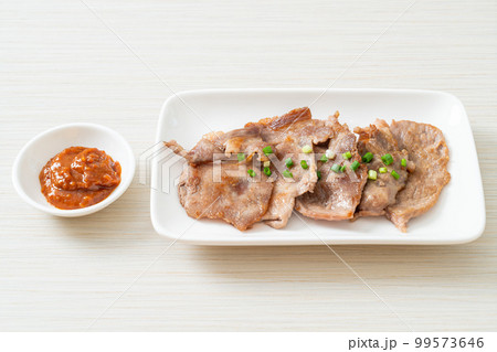 grilled pork neck sliced on plate 99573646
