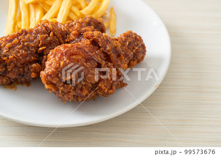 spicy Korean fried chicken with fries spicy Korean fried chicken with fries 99573676