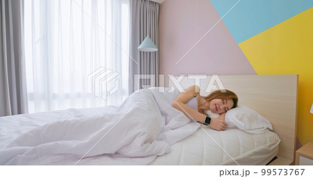 Woman sleeping with smart watch 99573767