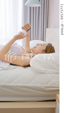 Woman wake up with smartwatch 99573771