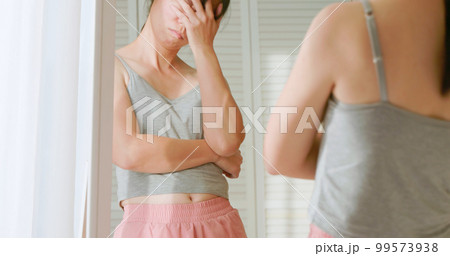 woman dissatisfied about body shape 99573938