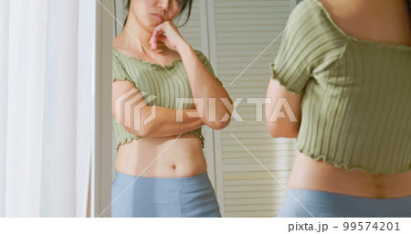 woman dissatisfied about body shape woman dissatisfied about body shape 99574201