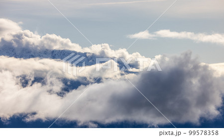 Tantalus Range covered in Snow and Clouds during Winter Season. 99578358