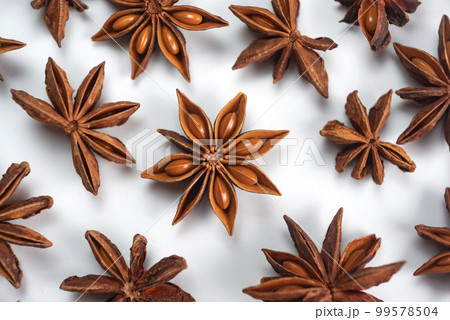 A lot of star anise on a white background close-up A lot of star anise on a white background close-up 99578504
