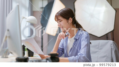 Photographer examine photo Photographer examine photo 99579213