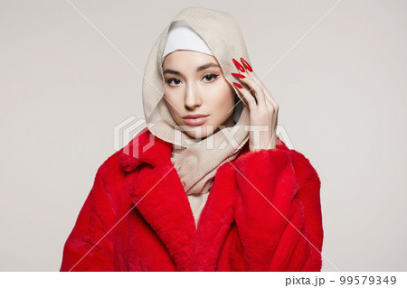 beautiful young woman in hijab and red fur. beauty stylish girl with long Nails beautiful young woman in hijab and red fur. beauty stylish girl with long Nails 99579349