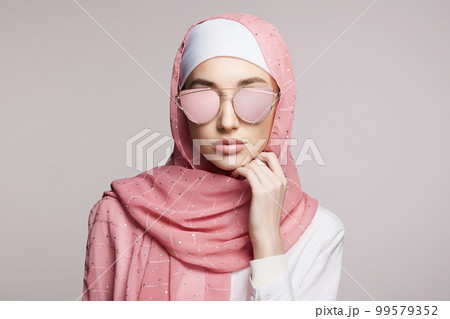beautiful islamic style young woman. beauty girl in hijab and sunglasses beautiful islamic style young woman. beauty girl in hijab and sunglasses 99579352